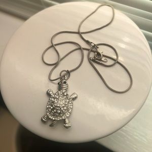 Silver sea turtle necklace.